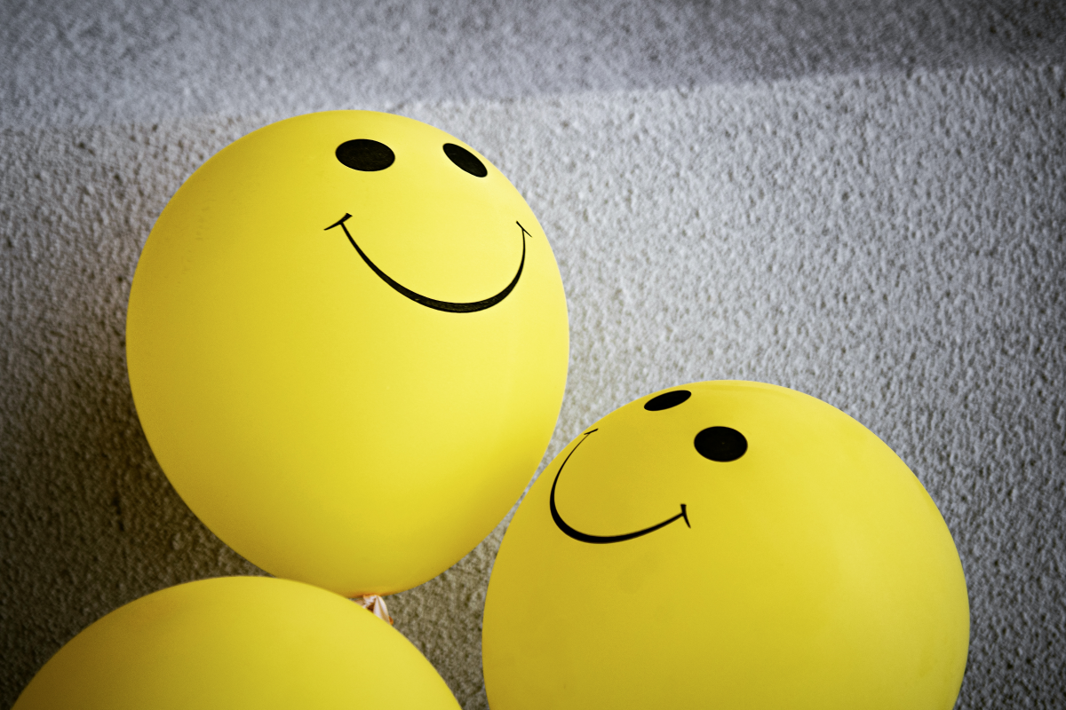 smiley face on yellow balloon